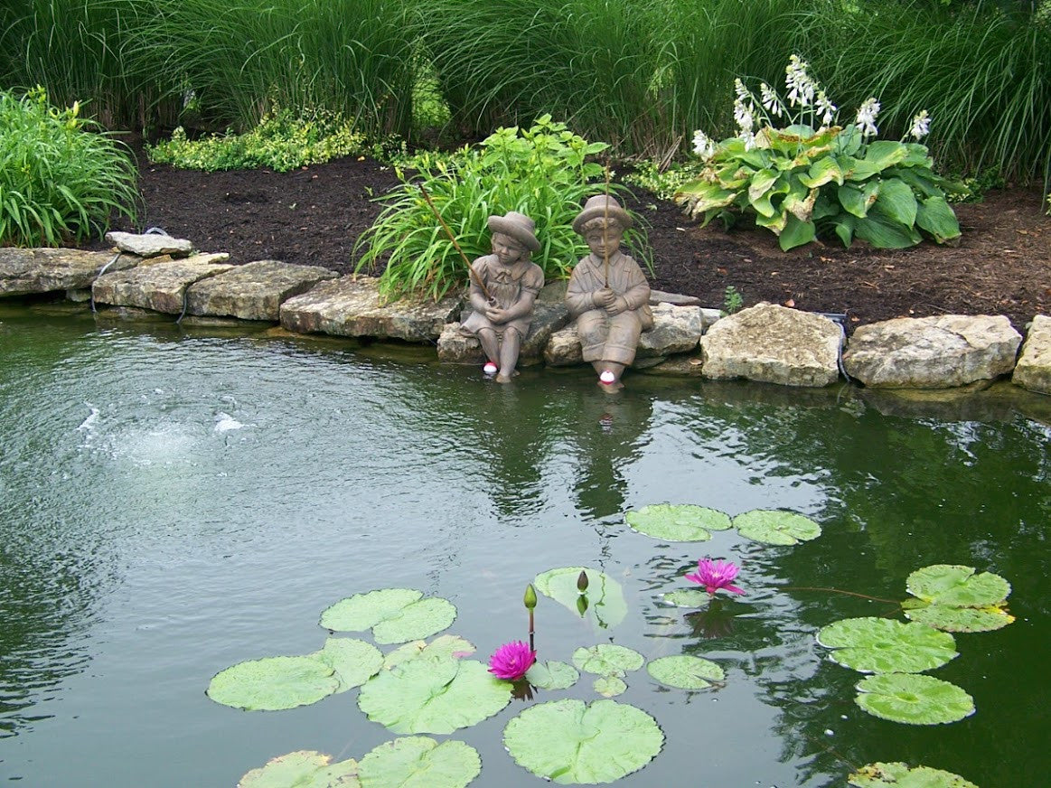 Fishing Boy & Girl Cast Stone Statues - Front View with Pond