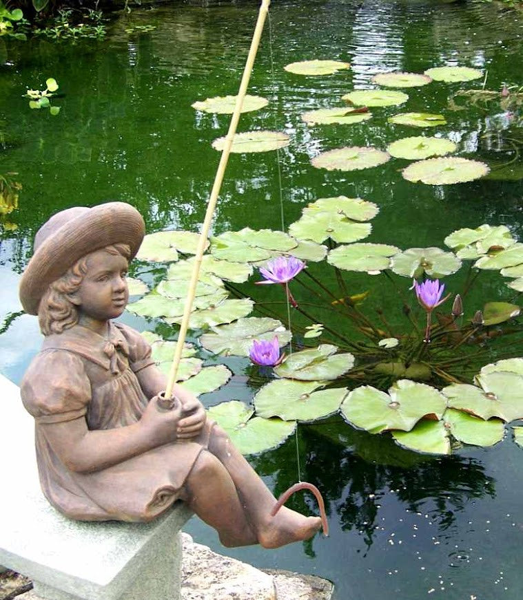 Fishing Girl Cast Stone Statue - Angled View By Pond